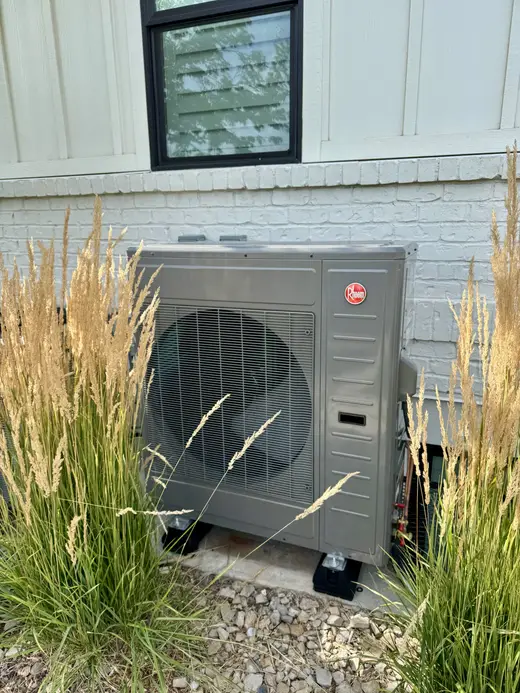 Outdoor Rheem air conditioning unit at a home